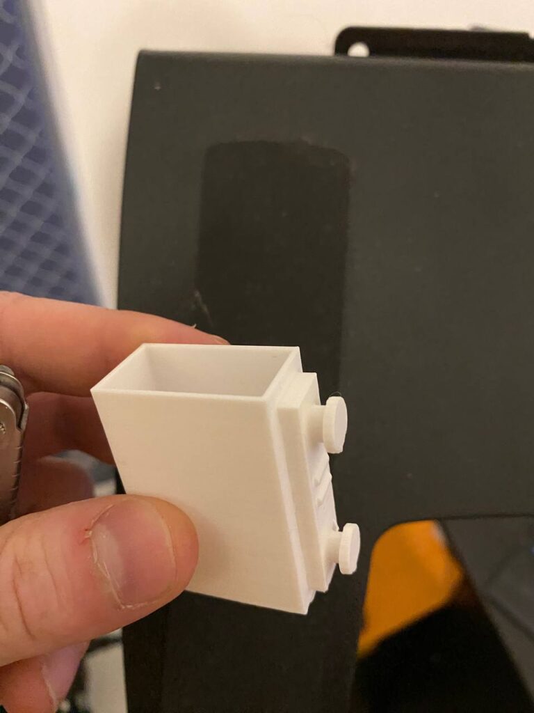 White brick-style container or desk piece